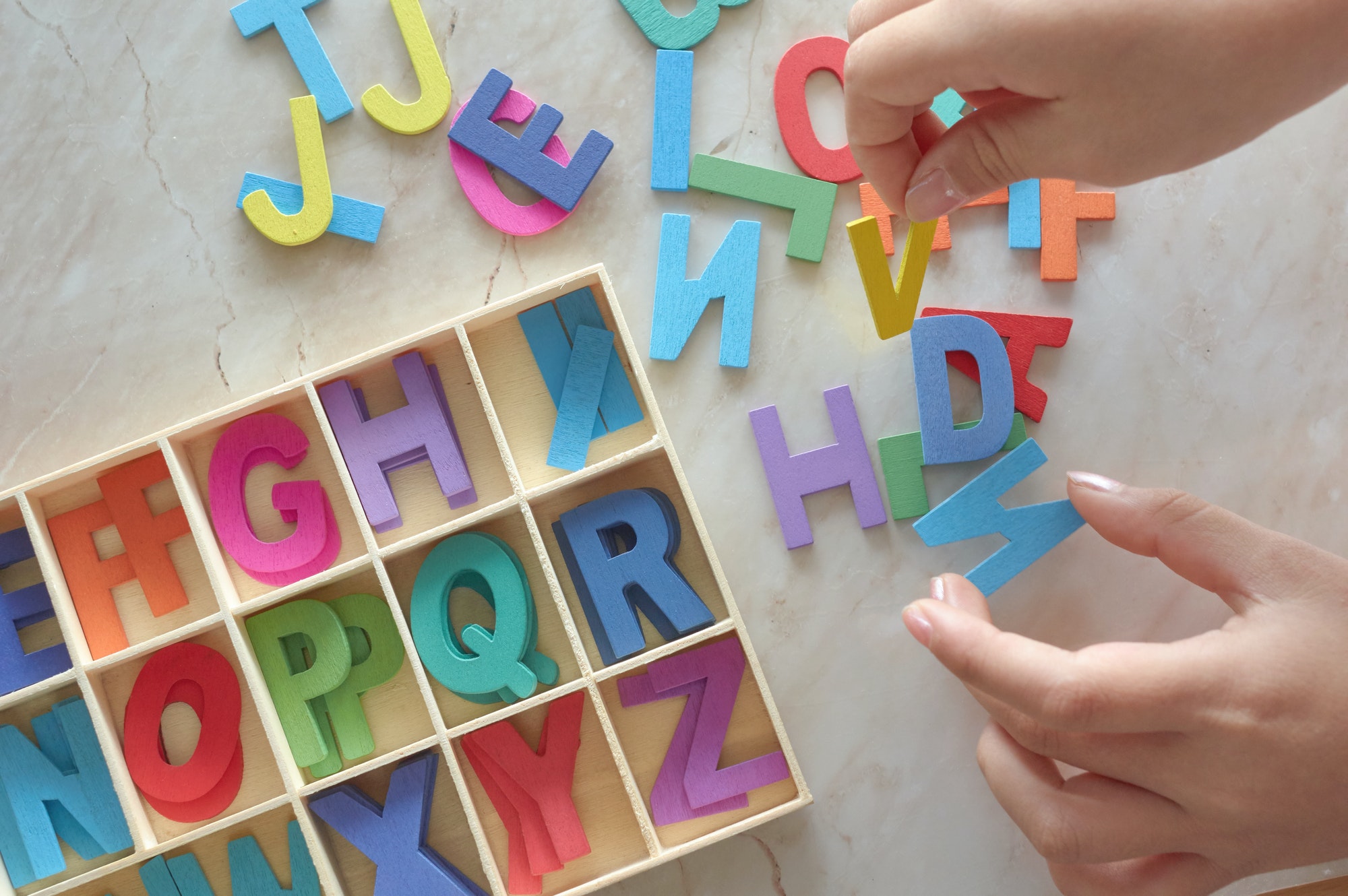 Child play the colorful wooden alphabet toy